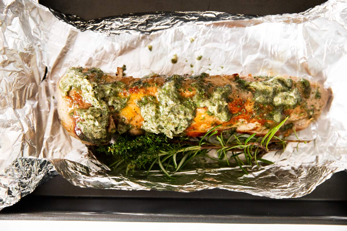 pork tenderloin with herbs on aluminum foil