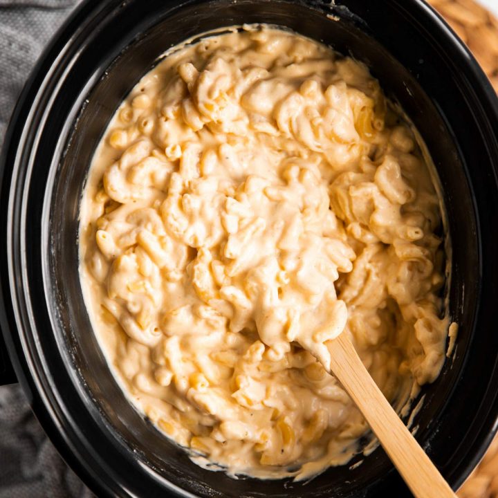 overhead view on crockpot with Mac and cheese and wooden spoon