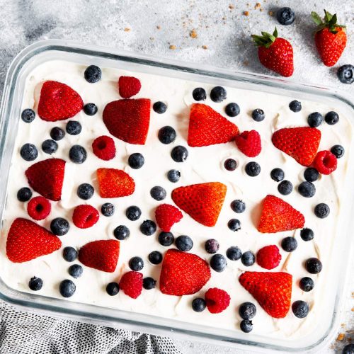 glass pan with icebox cake and fresh berries