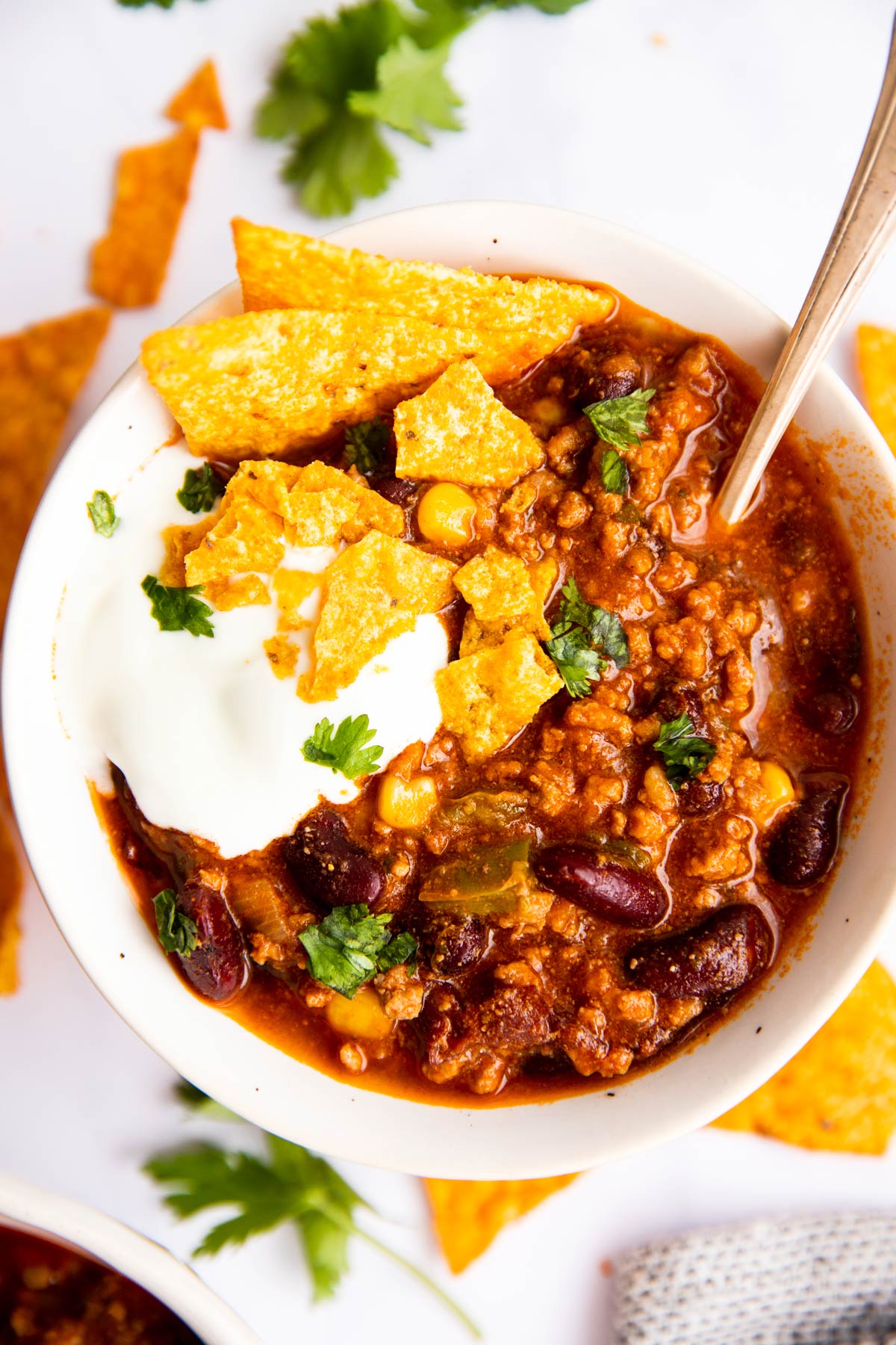 chili in a white bowl with toppings