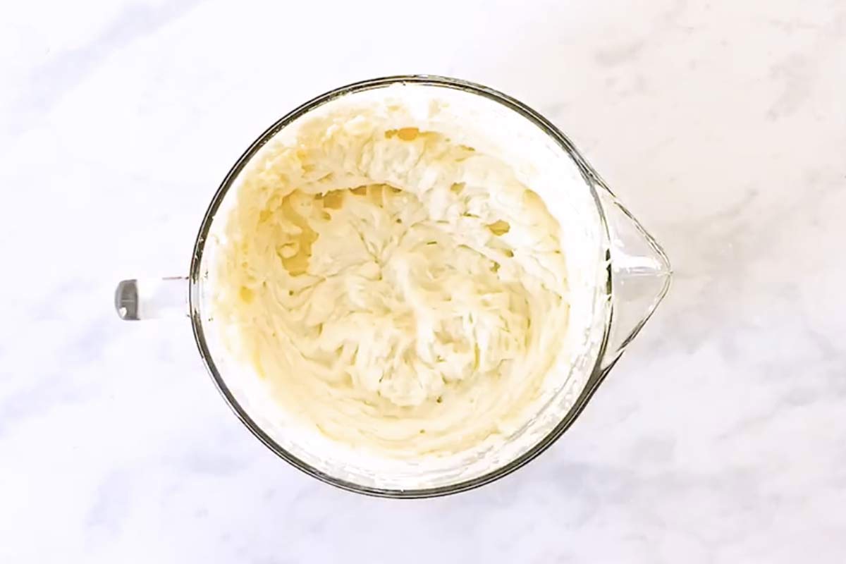 bowl with whipped topping on marble surface