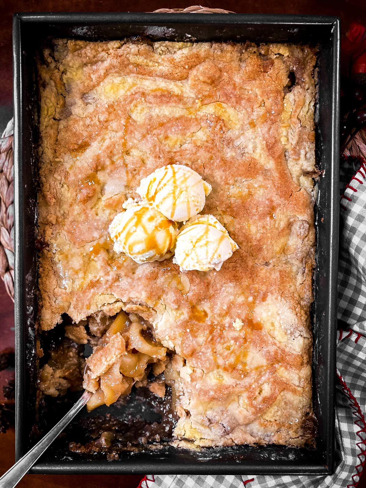 baked apple dump cake in a cake pan with ice cream