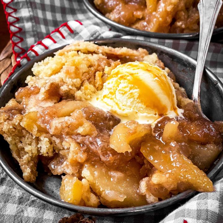 apple dump cake with ice cream in old metal plate