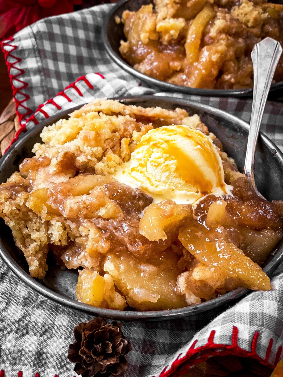 apple dump cake with ice cream in old metal plate