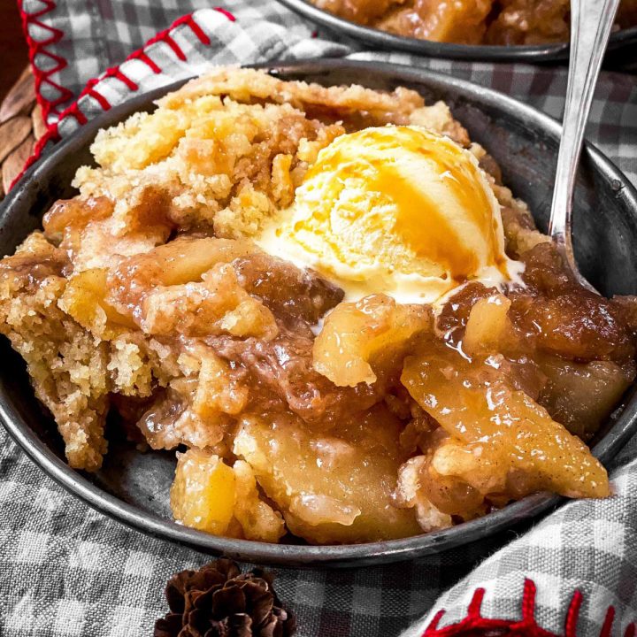 apple dump cake with ice cream in old metal plate