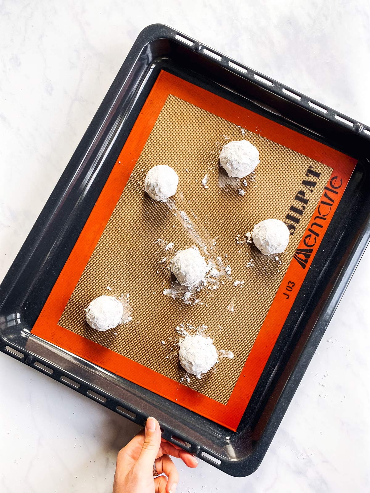 cookie sheet with unbaked cake mix crinkle cookies