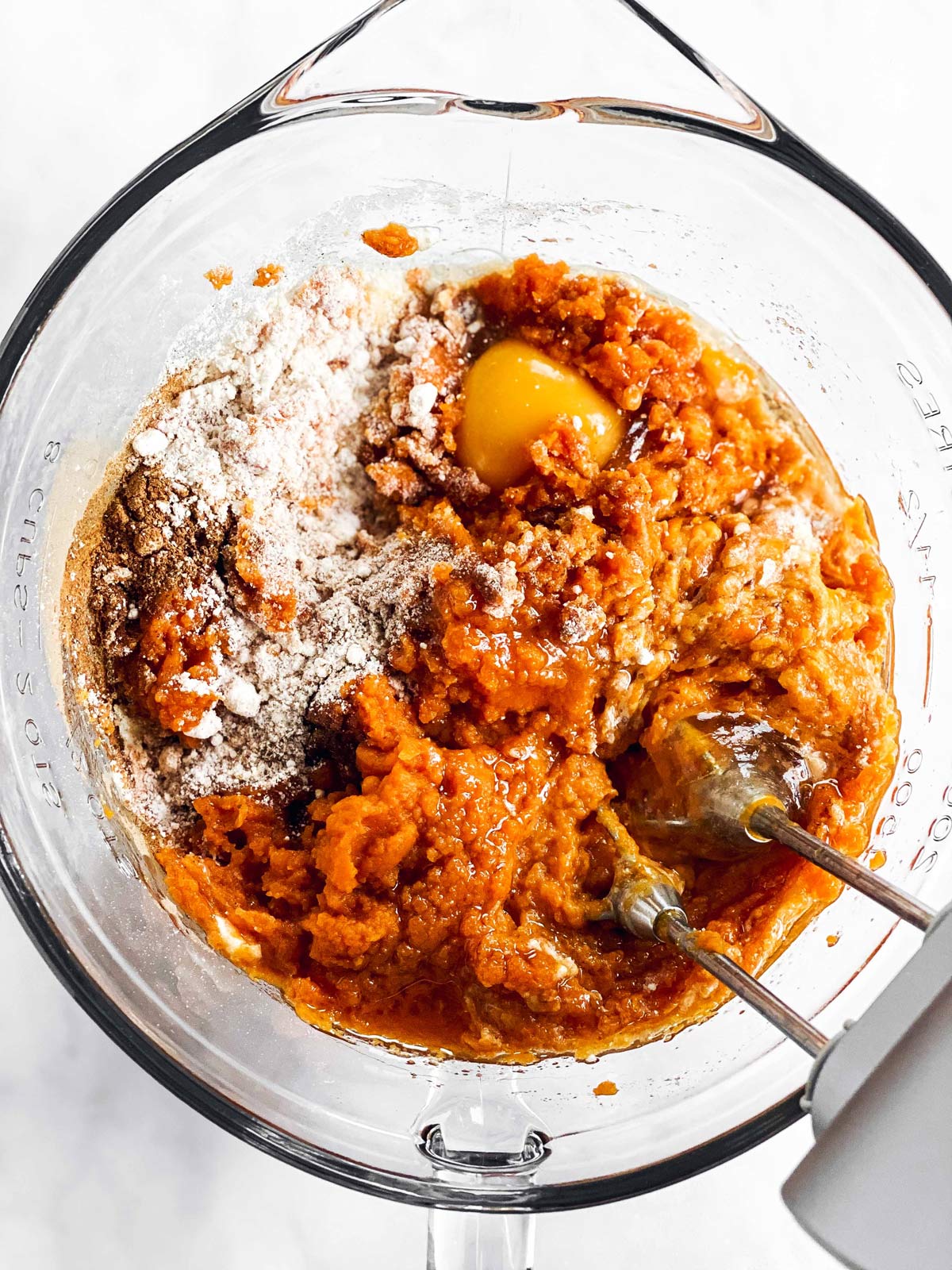 bowl with ingredients for pumpkin bread and beaters