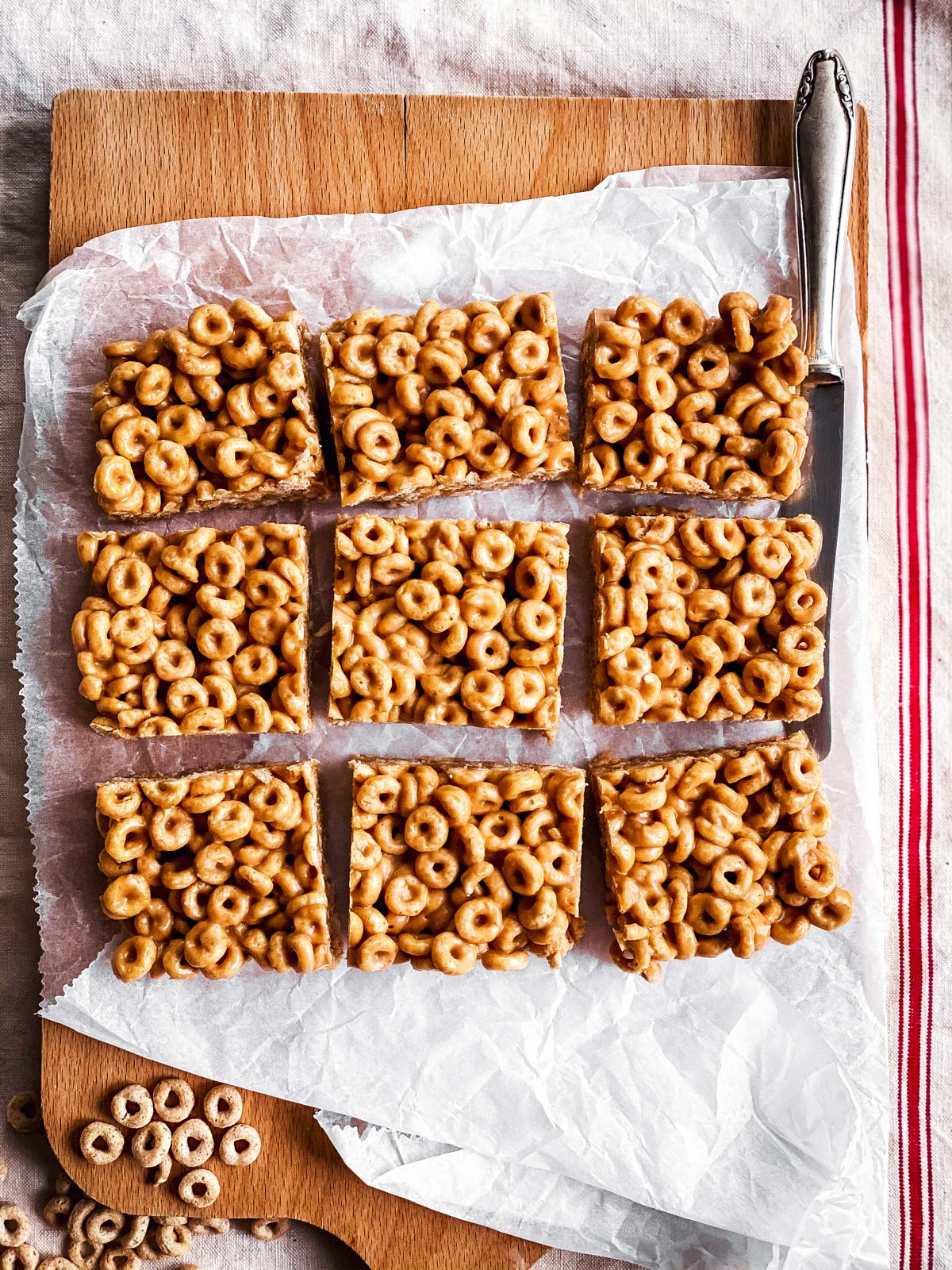 sliced peanut butter cheerio bars on wooden chopping board