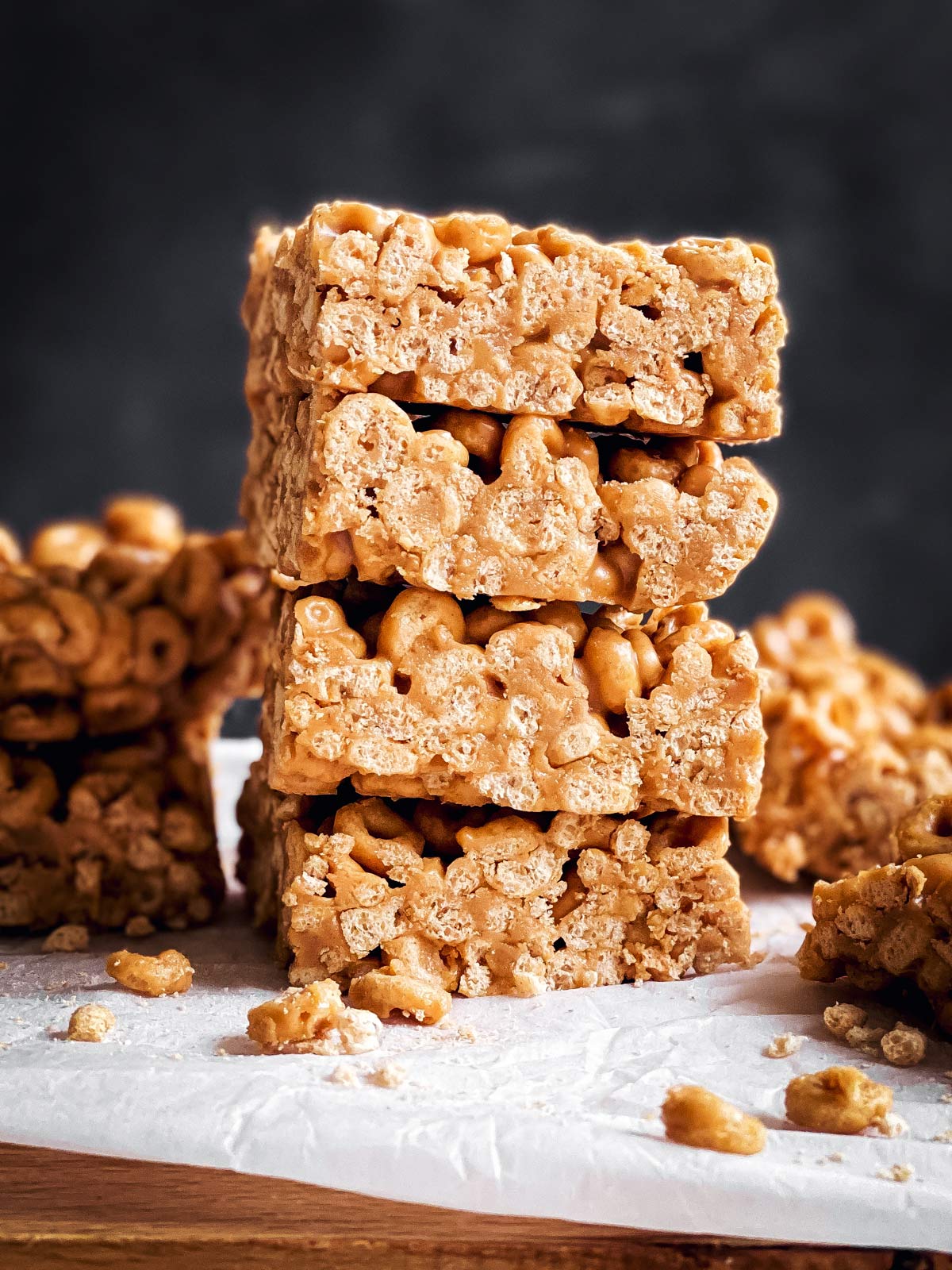 stack of peanut butter cheerio bars in front of a dark background