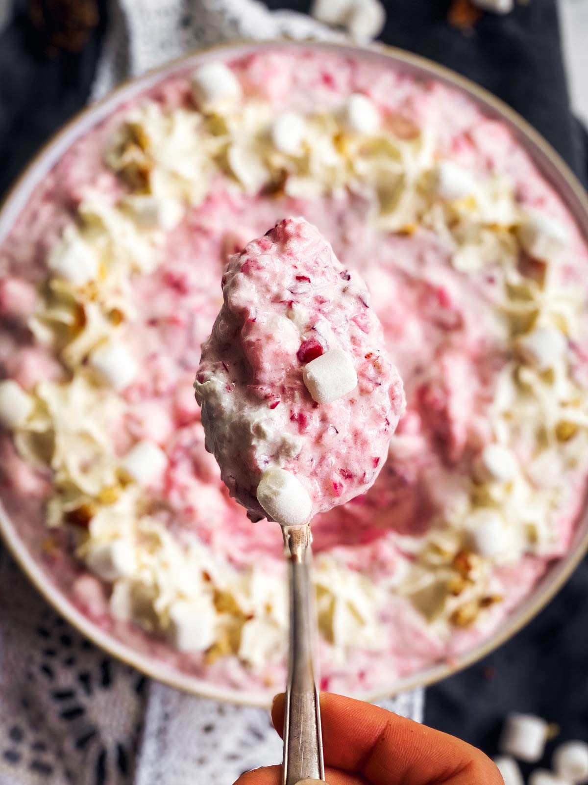close up of spoon with cranberry fluff salad