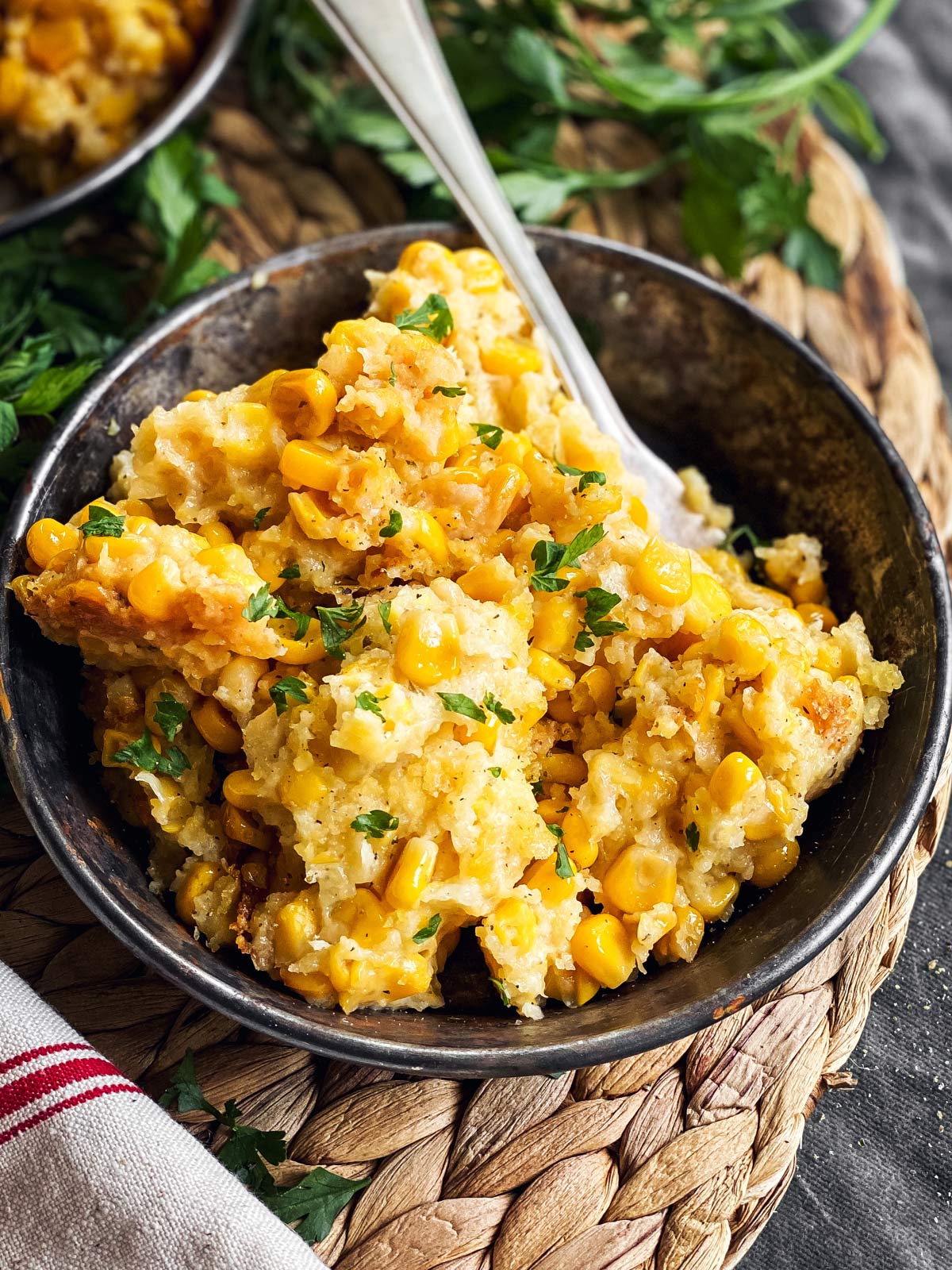 close up of corn casserole on a dark plate