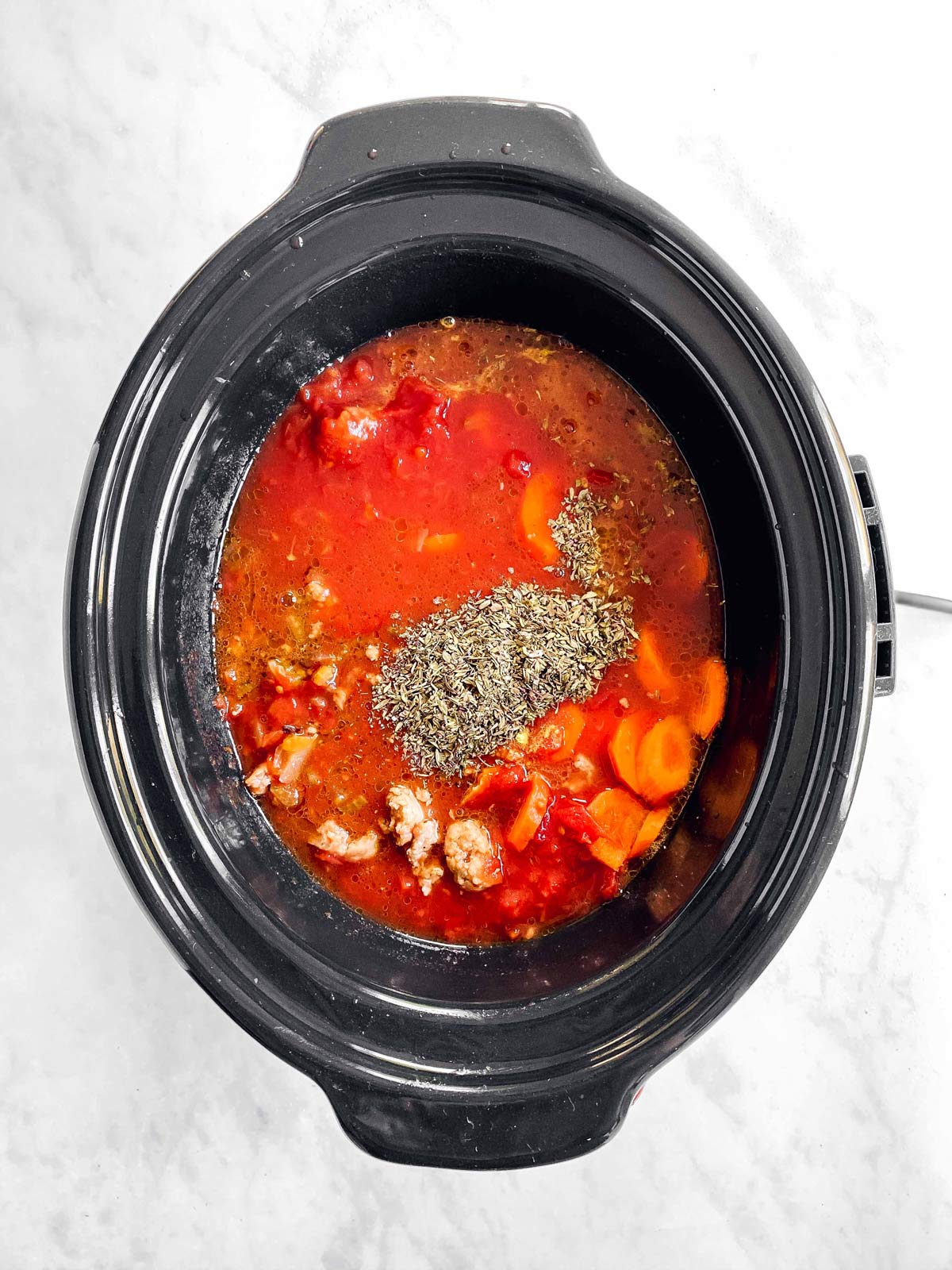 crockpot with ingredients for tortellini soup