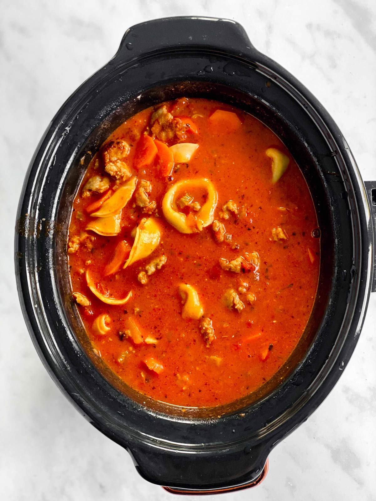 crockpot with half-cooked tortellini soup