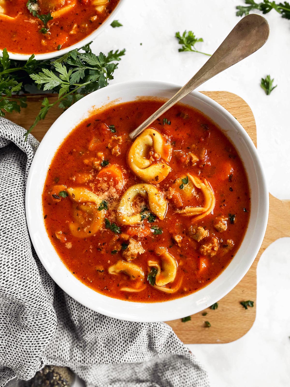 white soup plate with tortellini soup