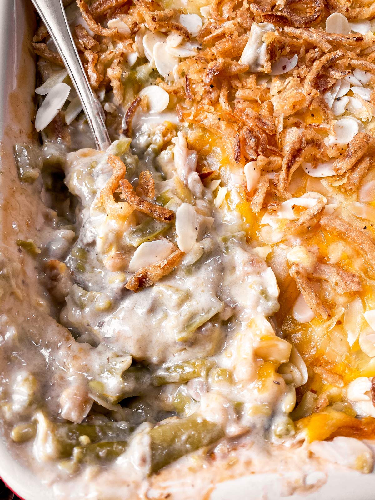 close up photo of spoon in green bean casserole
