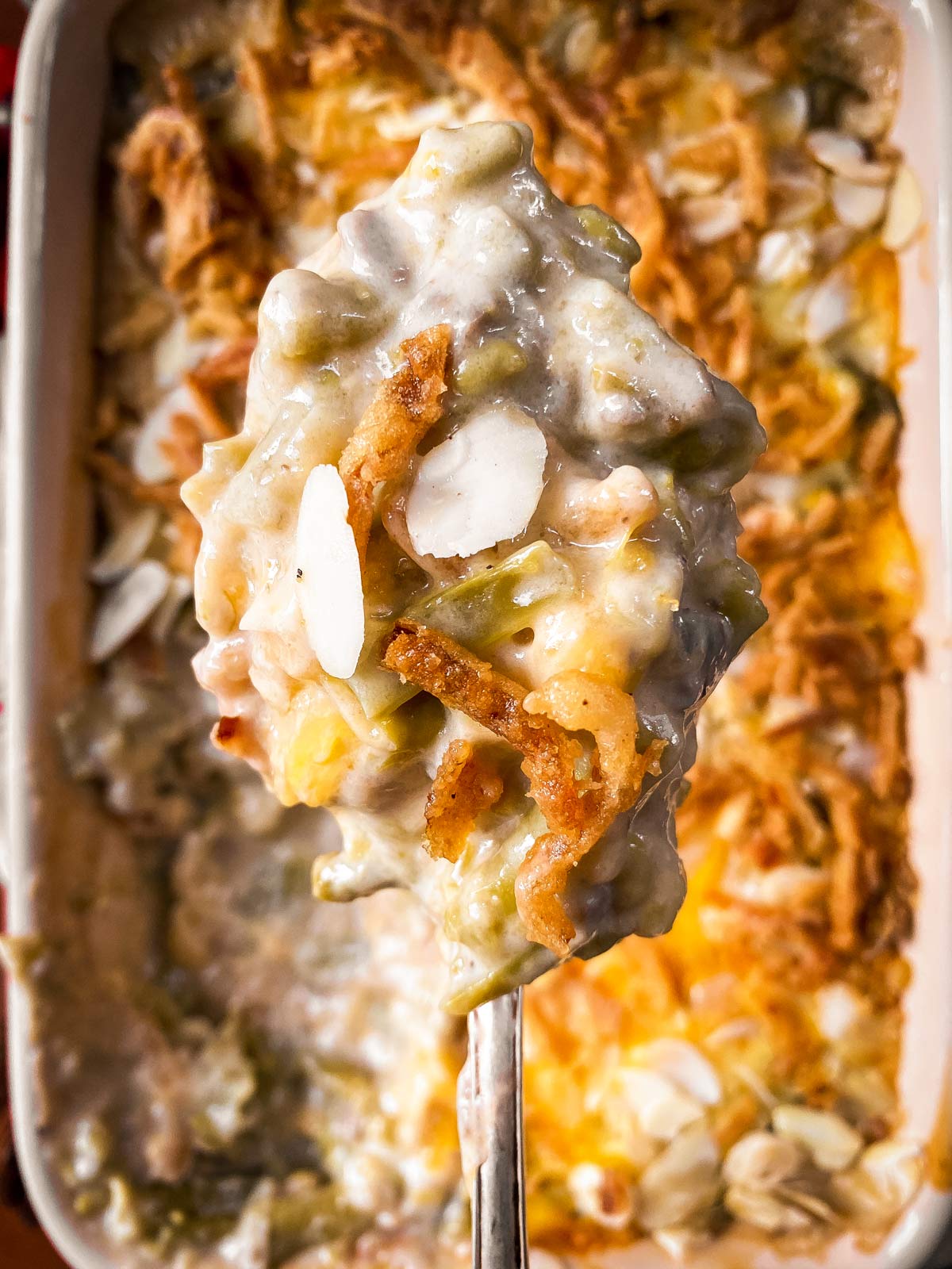 close up of spoon loaded with green bean casserole