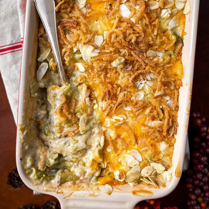 overhead view of baked green bean casserole in thanksgiving table setting