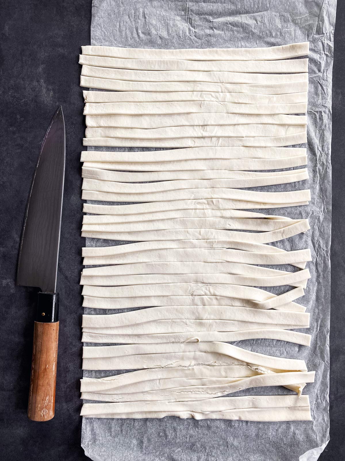 sliced puff pastry on a dark background