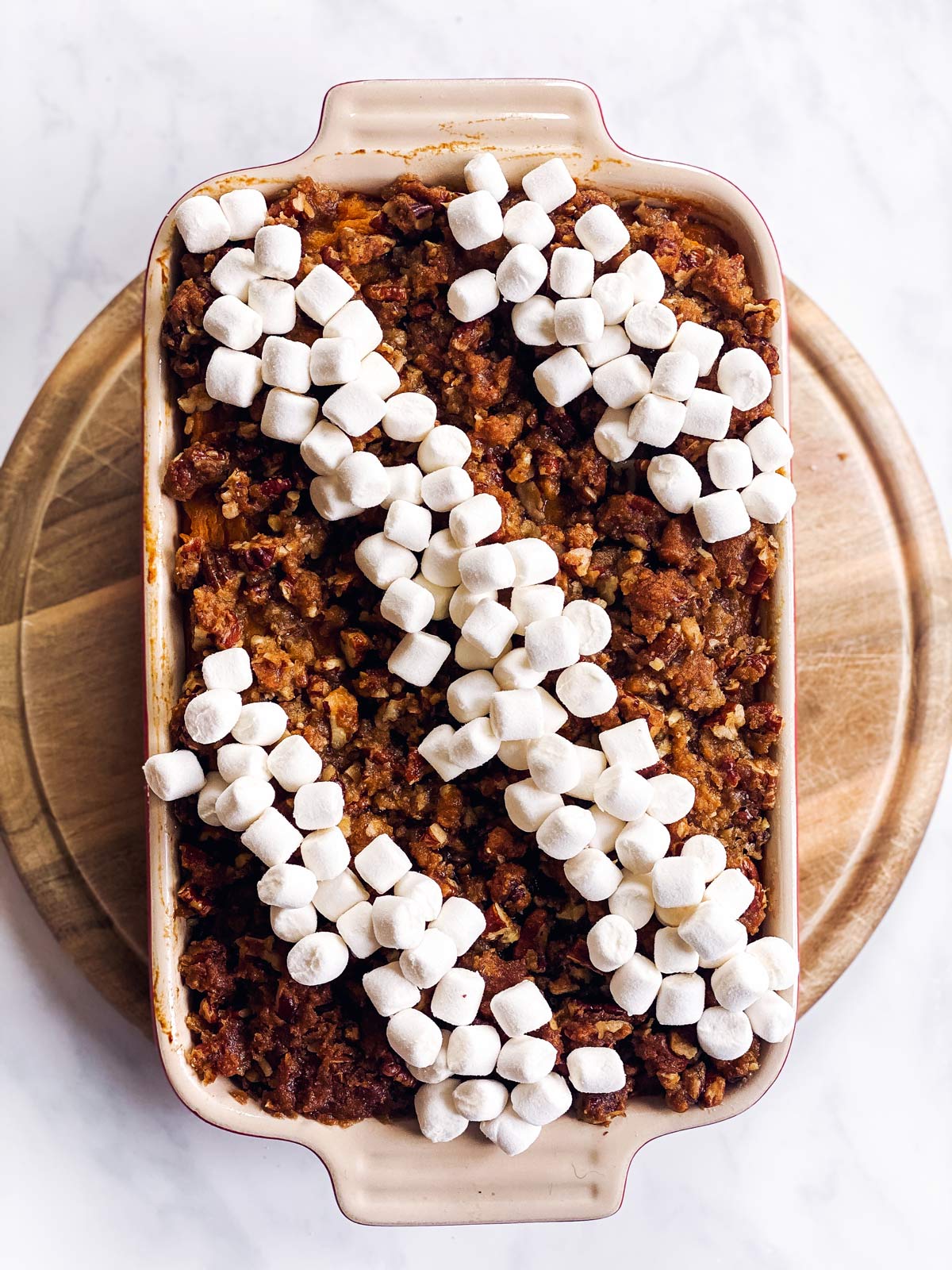 praline sweet potato casserole with unbaked marshmallows on top