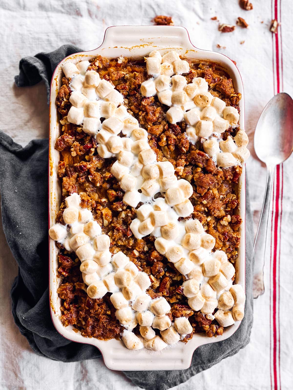 sweet potato casserole with marshmallows and pecan praline topping on a table cloth