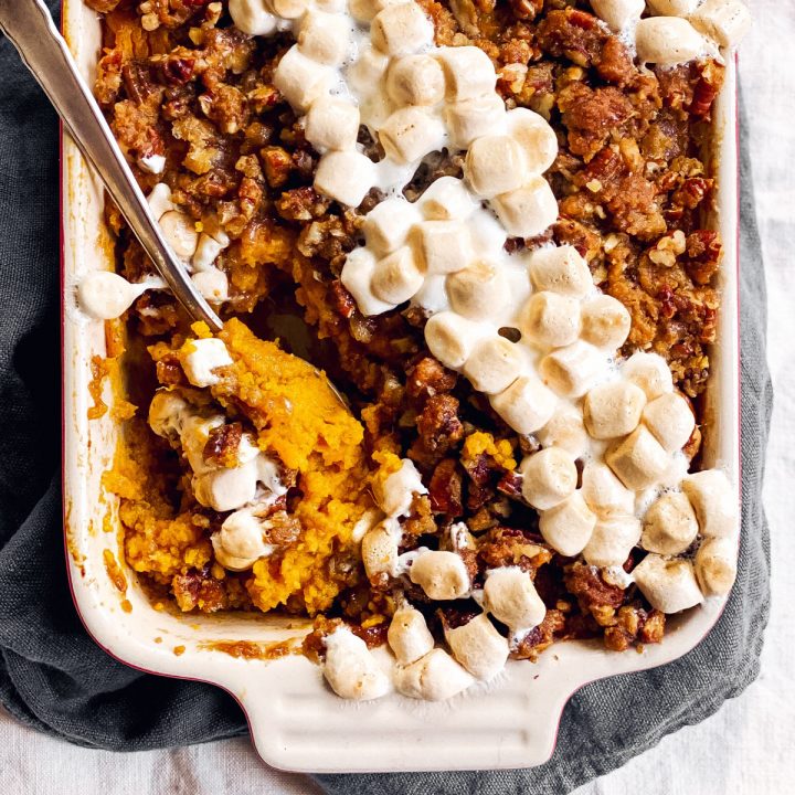 spoon sticking in marshmallow praline sweet potato casserole