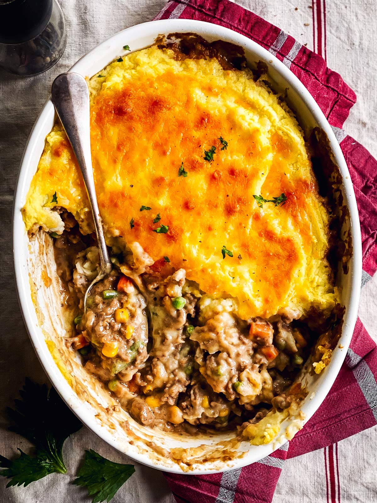 overhead view of shepherd's pie topped with instant mashed potatoes in white casserole dish