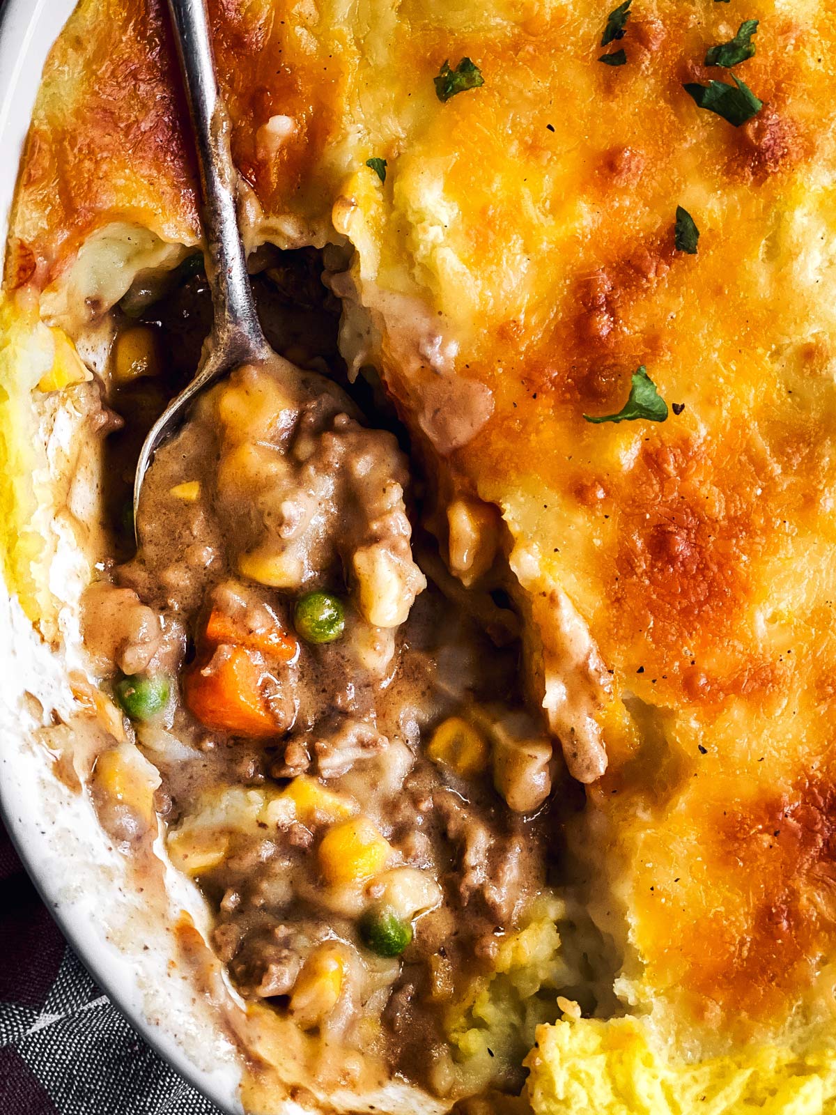 close up photo of serving spoon in shepherd's pie casserole