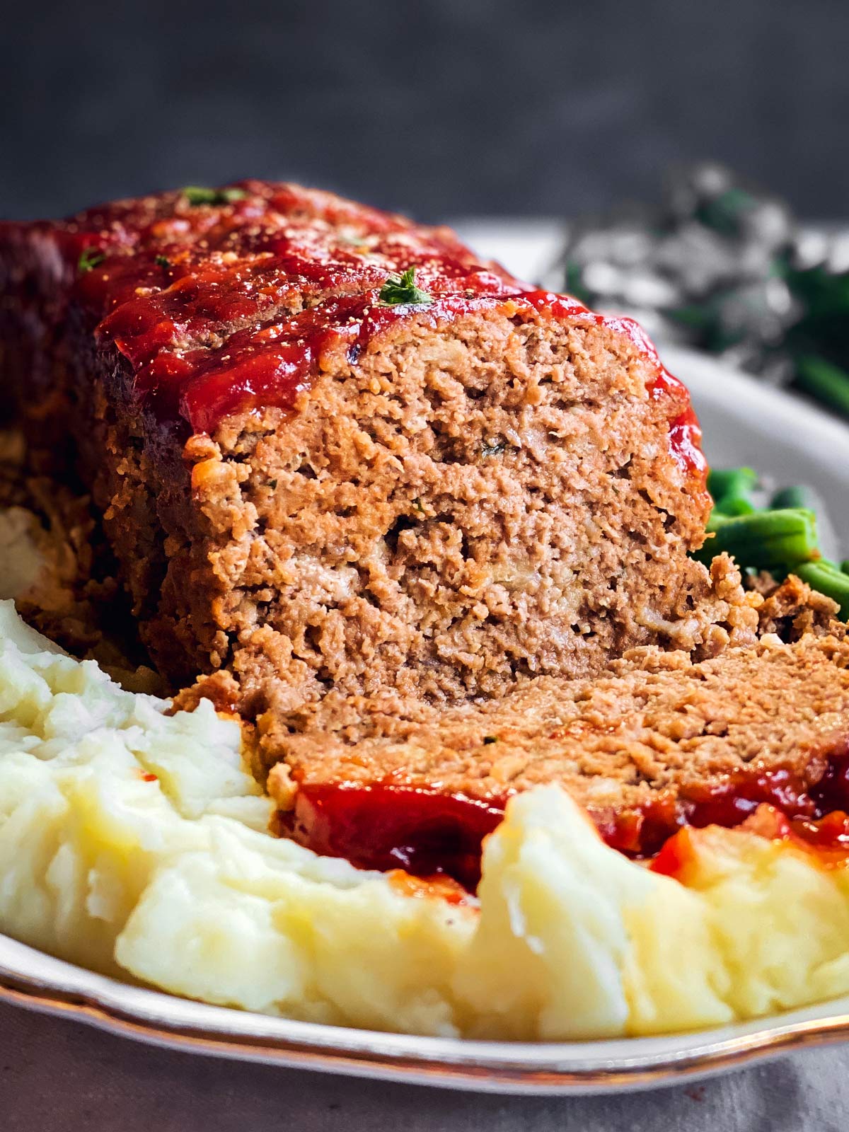 frontal view of sliced meatloaf on platter