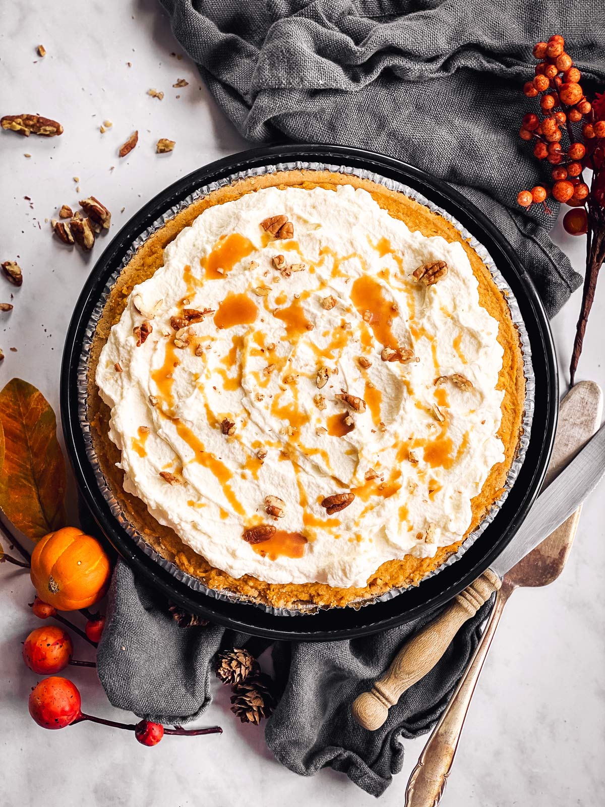 overhead view of decorated turtle pumpkin pie with decorative table arrangements