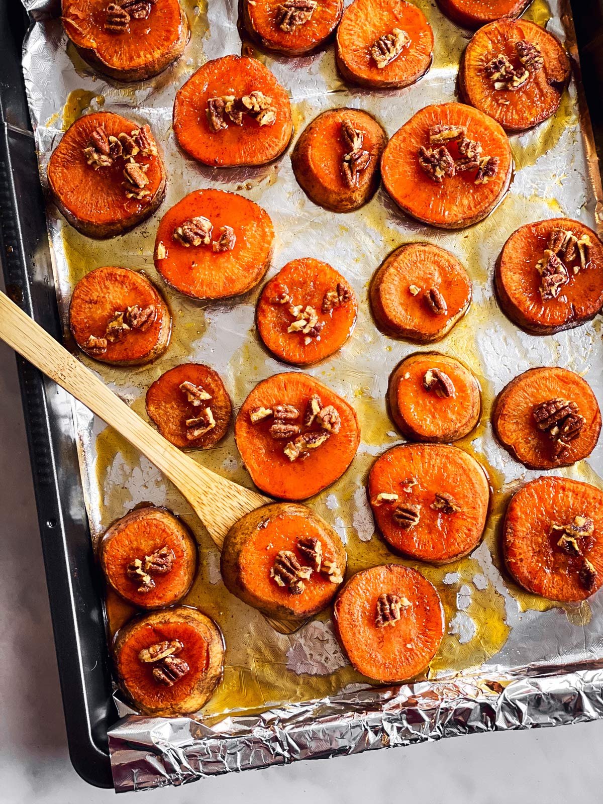 overhead view of baking sheet with baked sweet potato slices