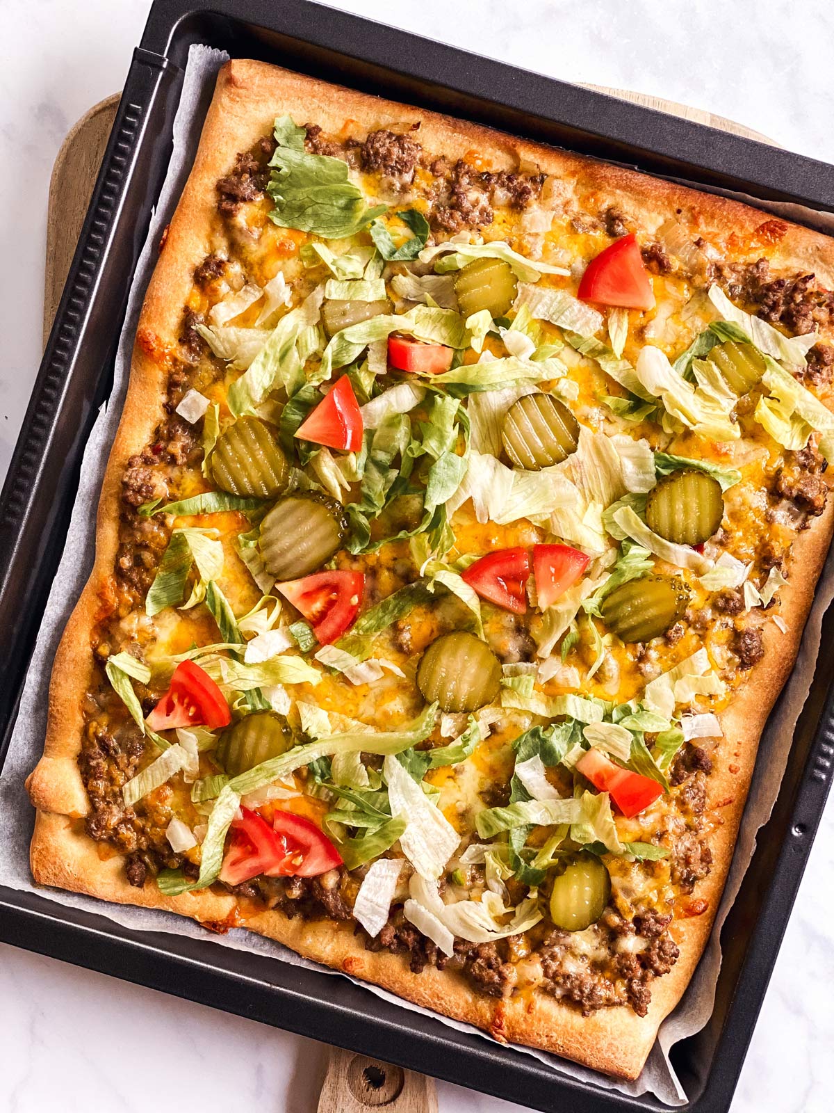 overhead view of garnished Big Mac pizza