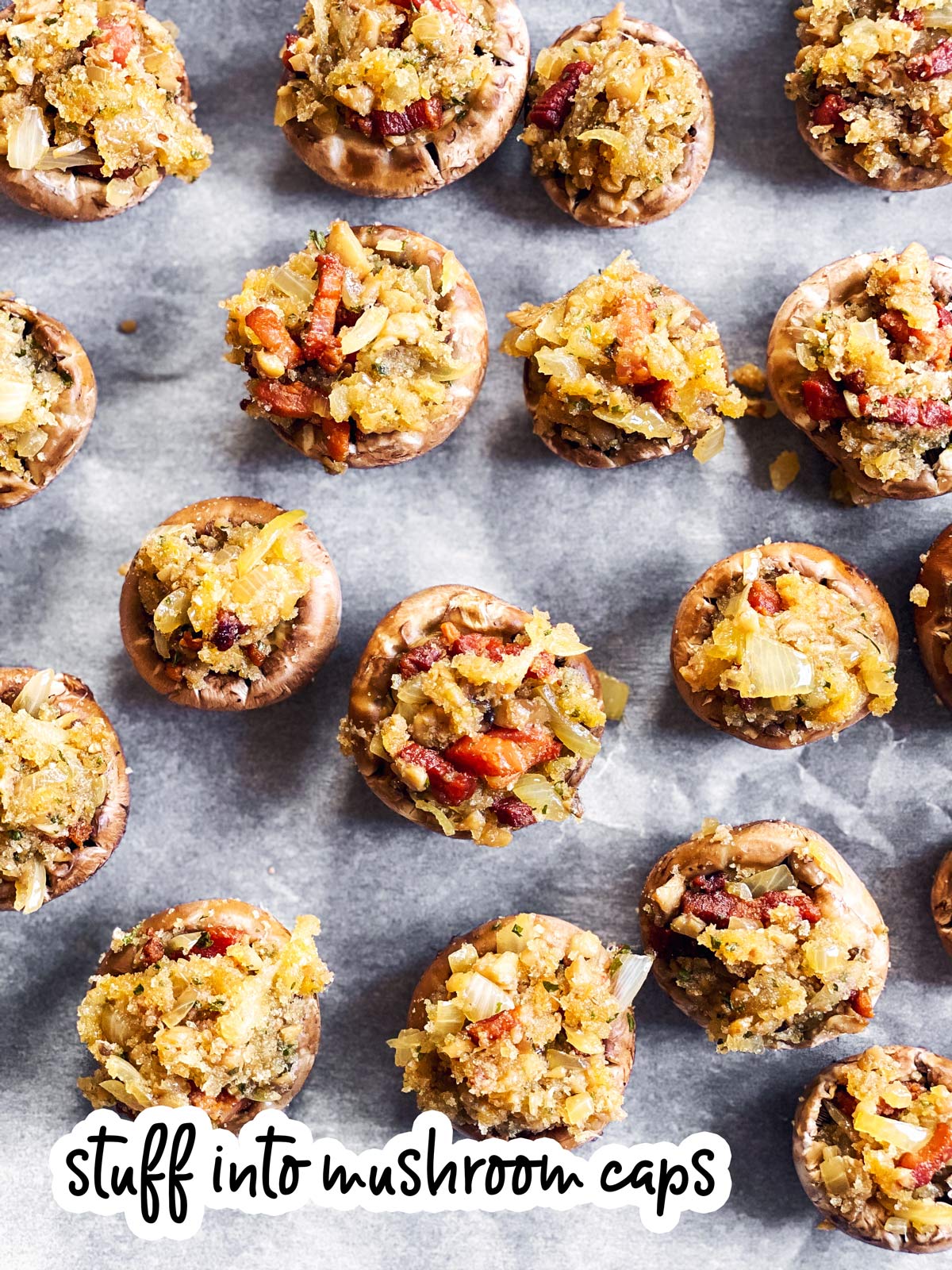 bacon stuffed mushrooms before baking on a baking parchment