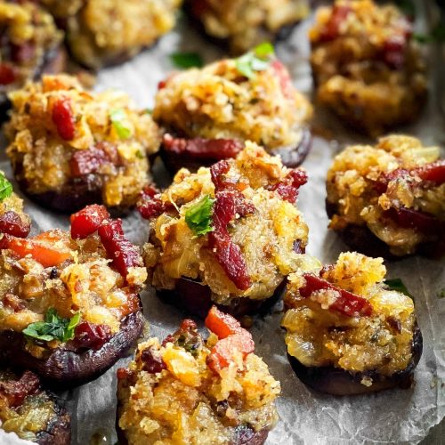 close up of a tray with cheese and bacon stuffed mushrooms