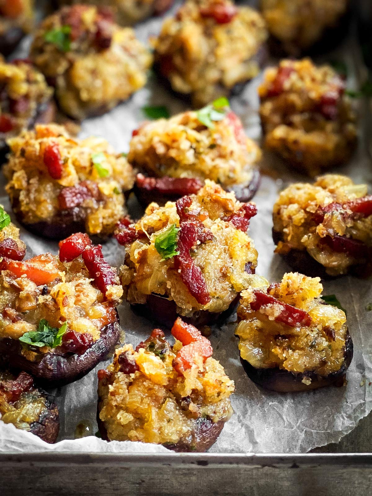 close up of a tray with cheese and bacon stuffed mushrooms
