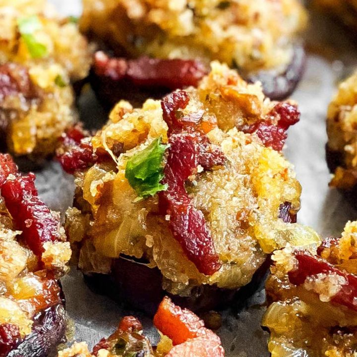 close up of a tray with cheese and bacon stuffed mushrooms