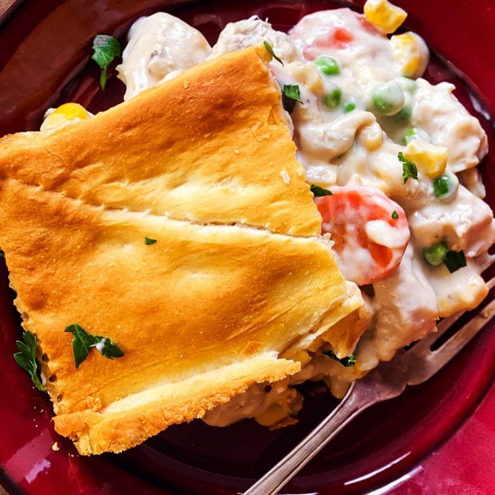 slice of leftover turkey pot pie on red plate