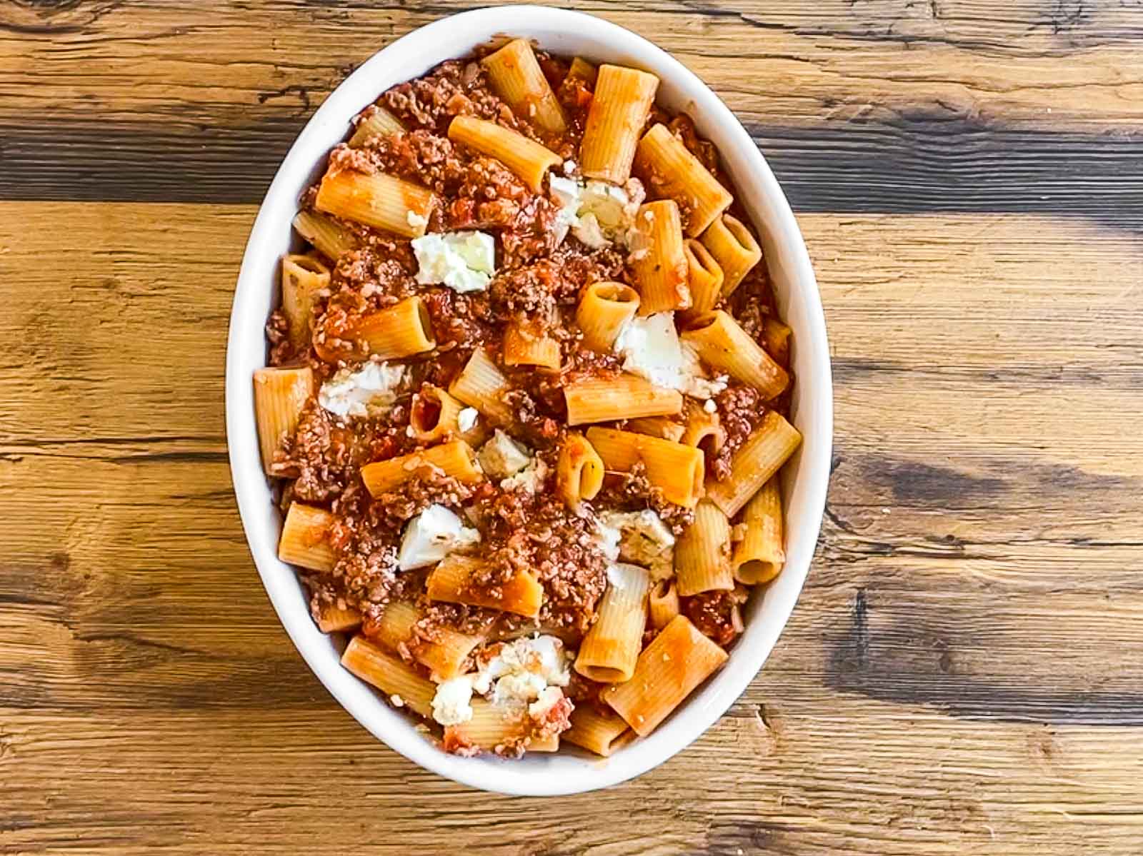 rigatoni with bolognese sauce in casserole dish with cream cheese