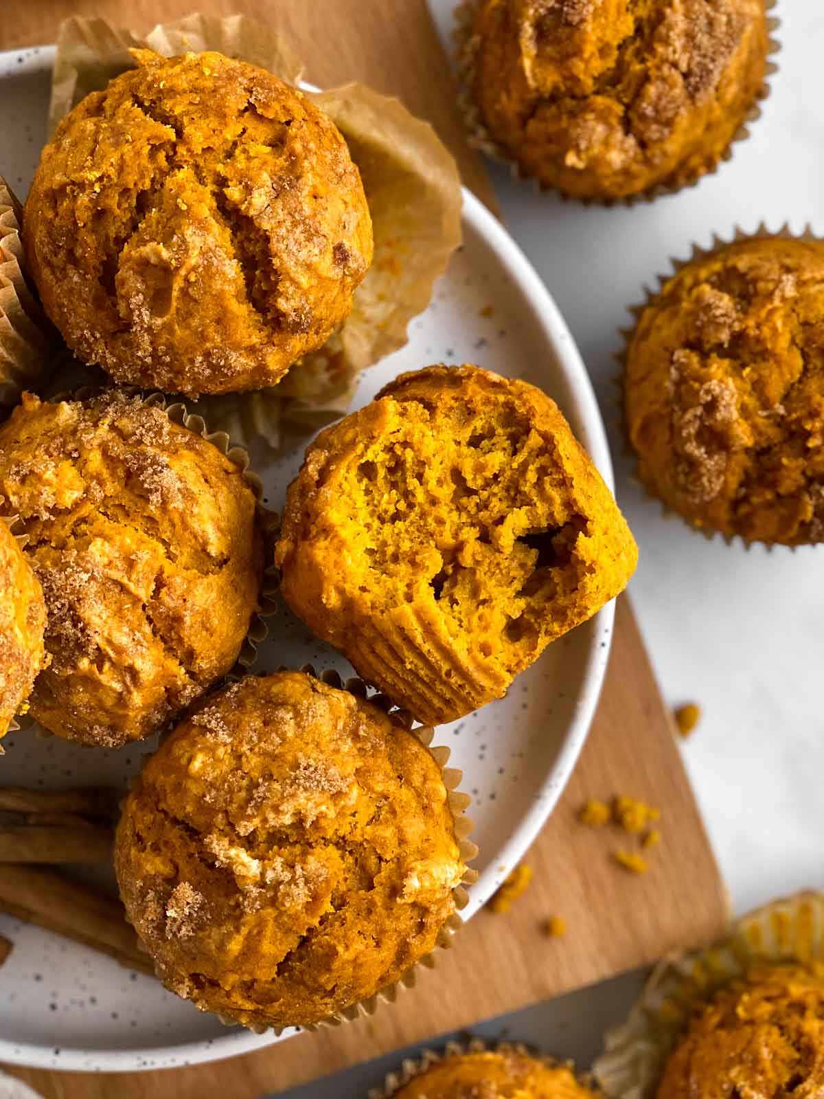 overhead view of several pumpkin muffins on white plate