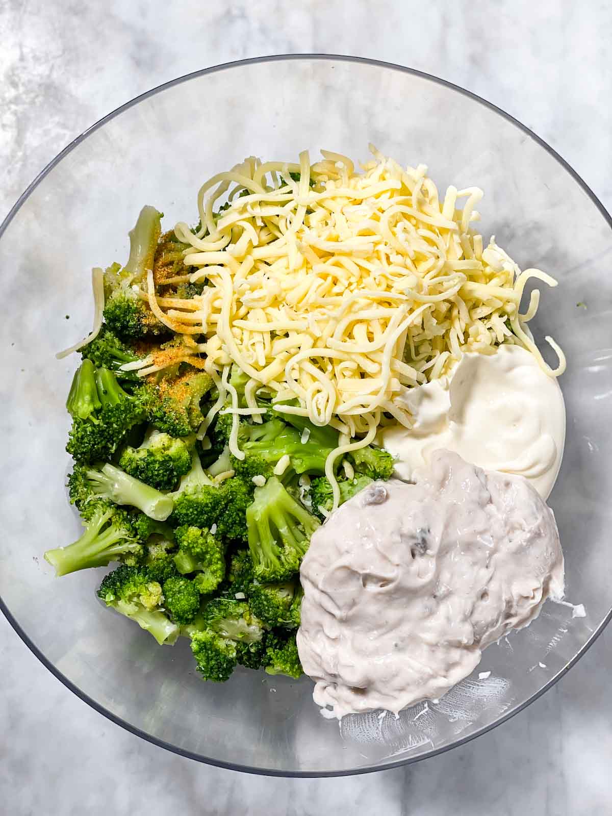 ingredients for ritz broccoli casserole in glass bowl