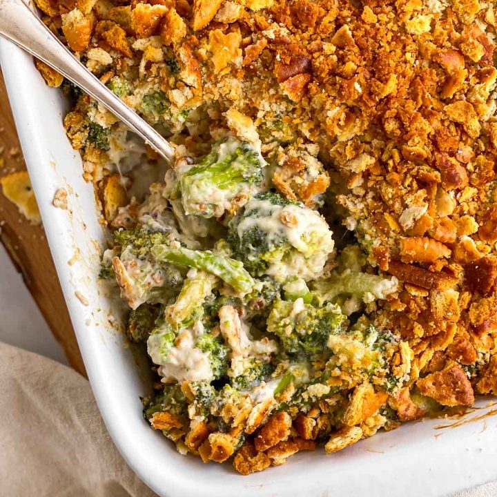 overhead view of ritz broccoli casserole in white dish with spoon stuck in