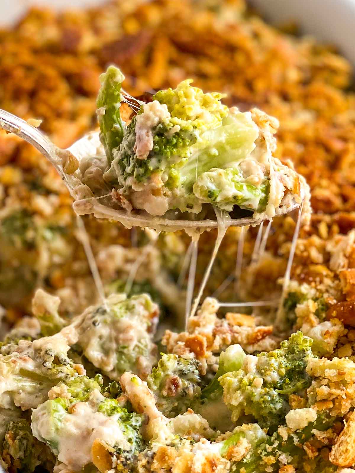 spoon scooping out broccoli casserole