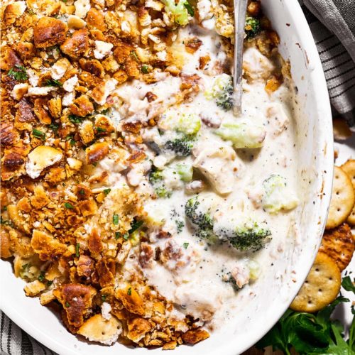 overhead view of spoon in dish with ritz chicken and broccoli casserole