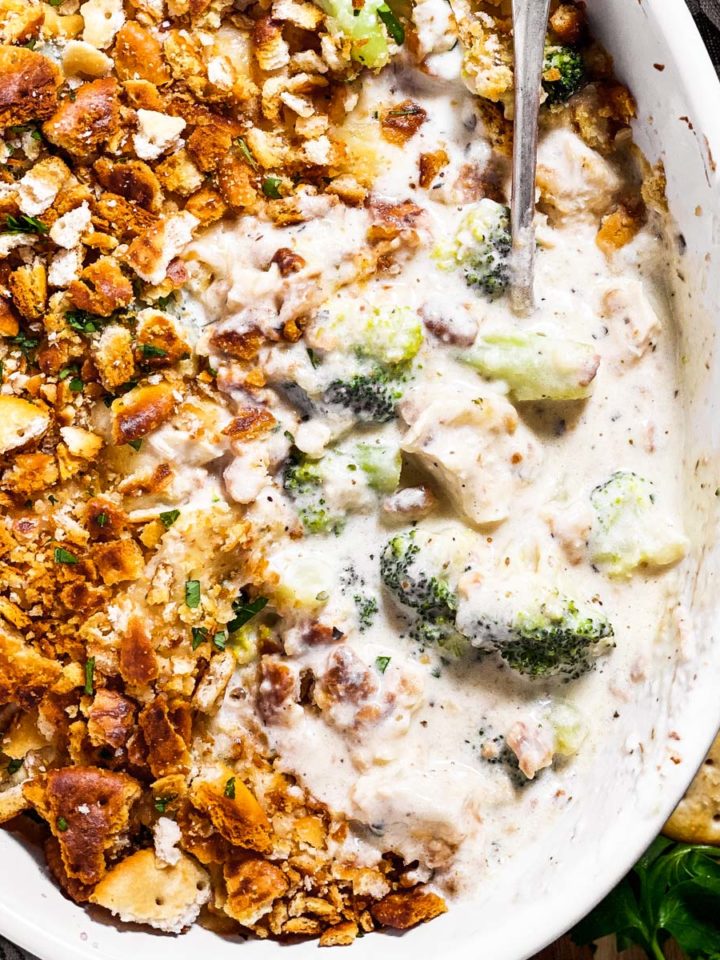 overhead view of spoon in dish with ritz chicken and broccoli casserole