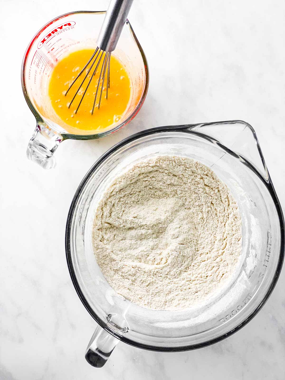 dry ingredients and wet ingredients for cookie dough in two separate glass bowls