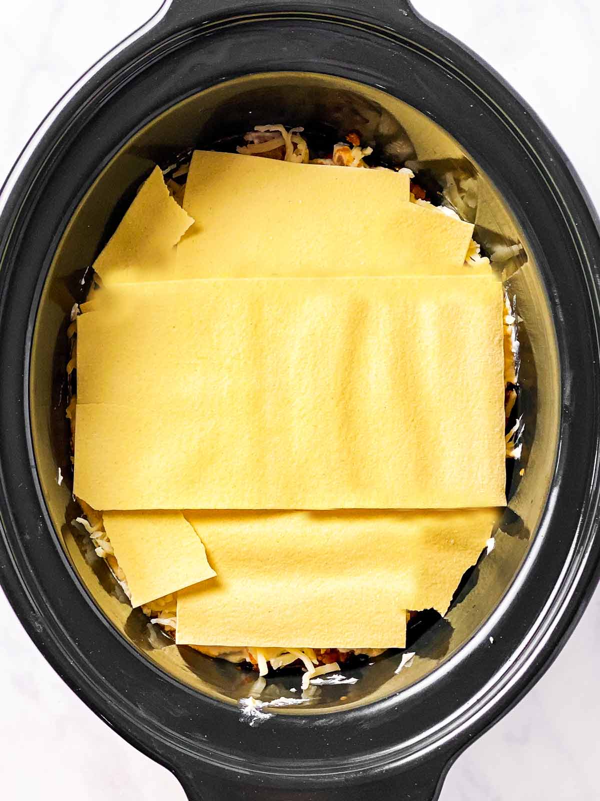 dry lasagna noodles in black crock (third layer)