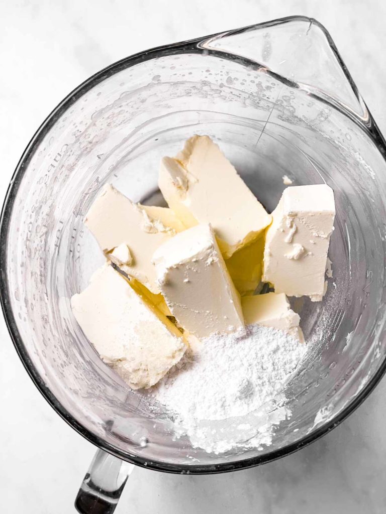 cream cheese and sugar in glass bowl