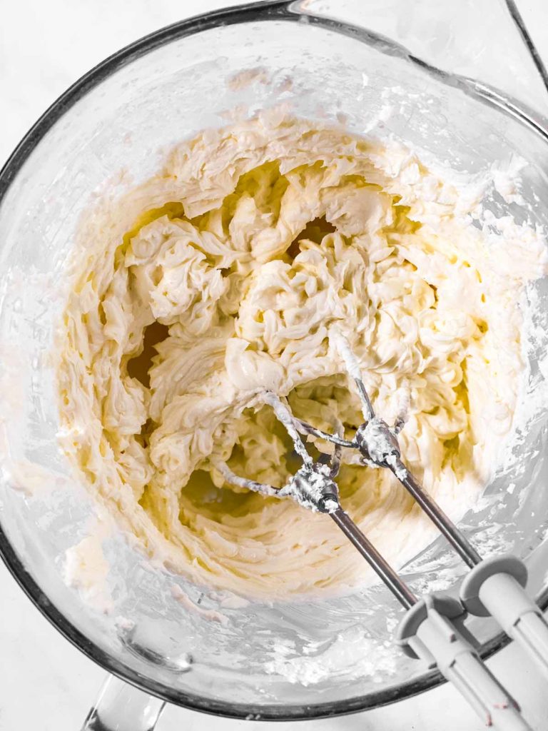 beaten cream cheese in glass bowl