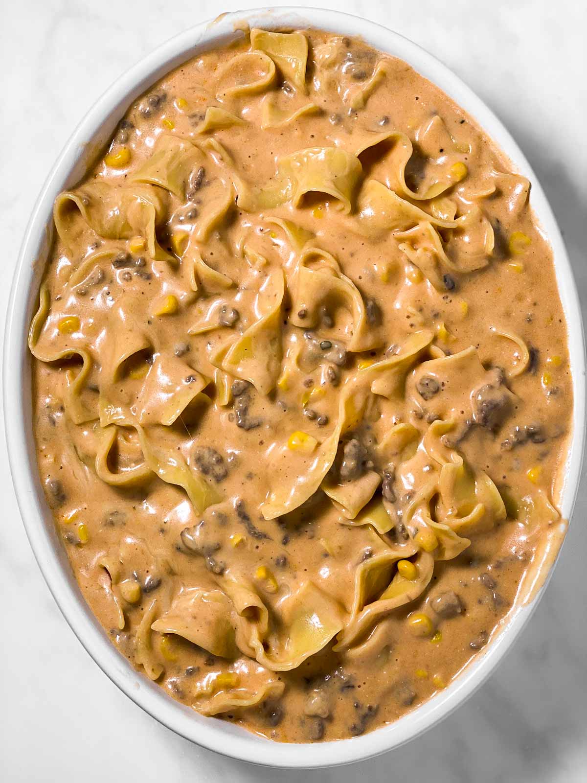 beef and noodle mixture in oval casserole dish