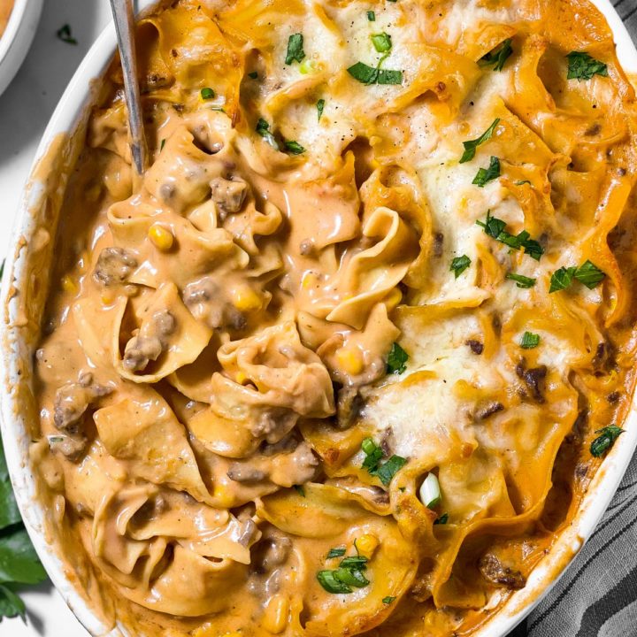 overhead view of white oval casserole dish filled with hamburger noodle casserole