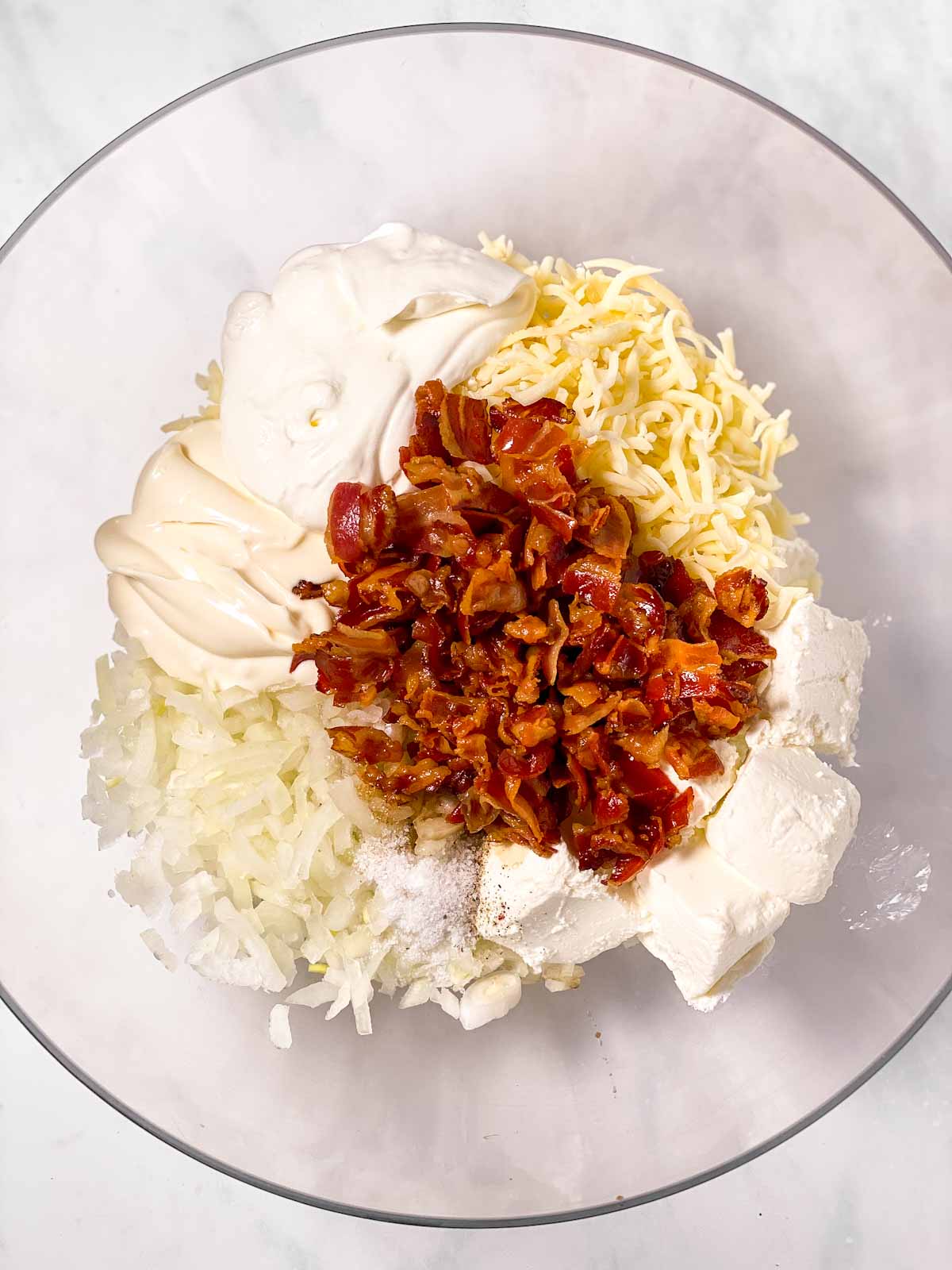 ingredients for hot onion dip in glass bowl